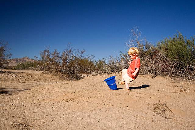 toddler in red shirt kicking the bucket