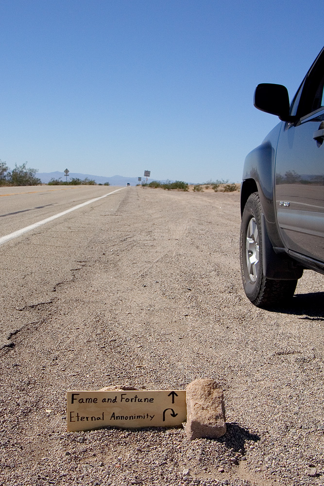 small sign on route 66, fame and fortune ahead, eternal annonimity back